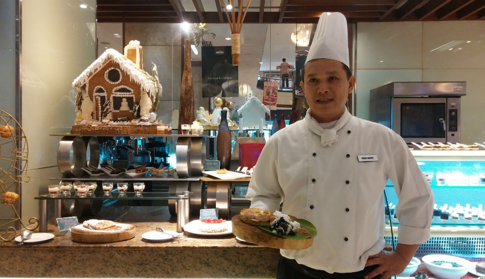 Marco Polo chef shows off the dessert station's new dishes.