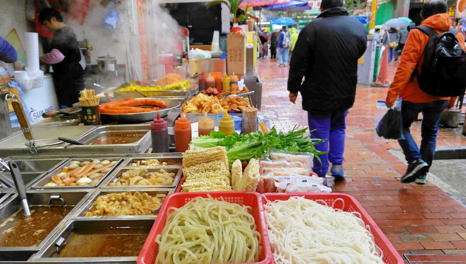 STREET FOOD. Old school noodles on the street that sells the latest gadgets.