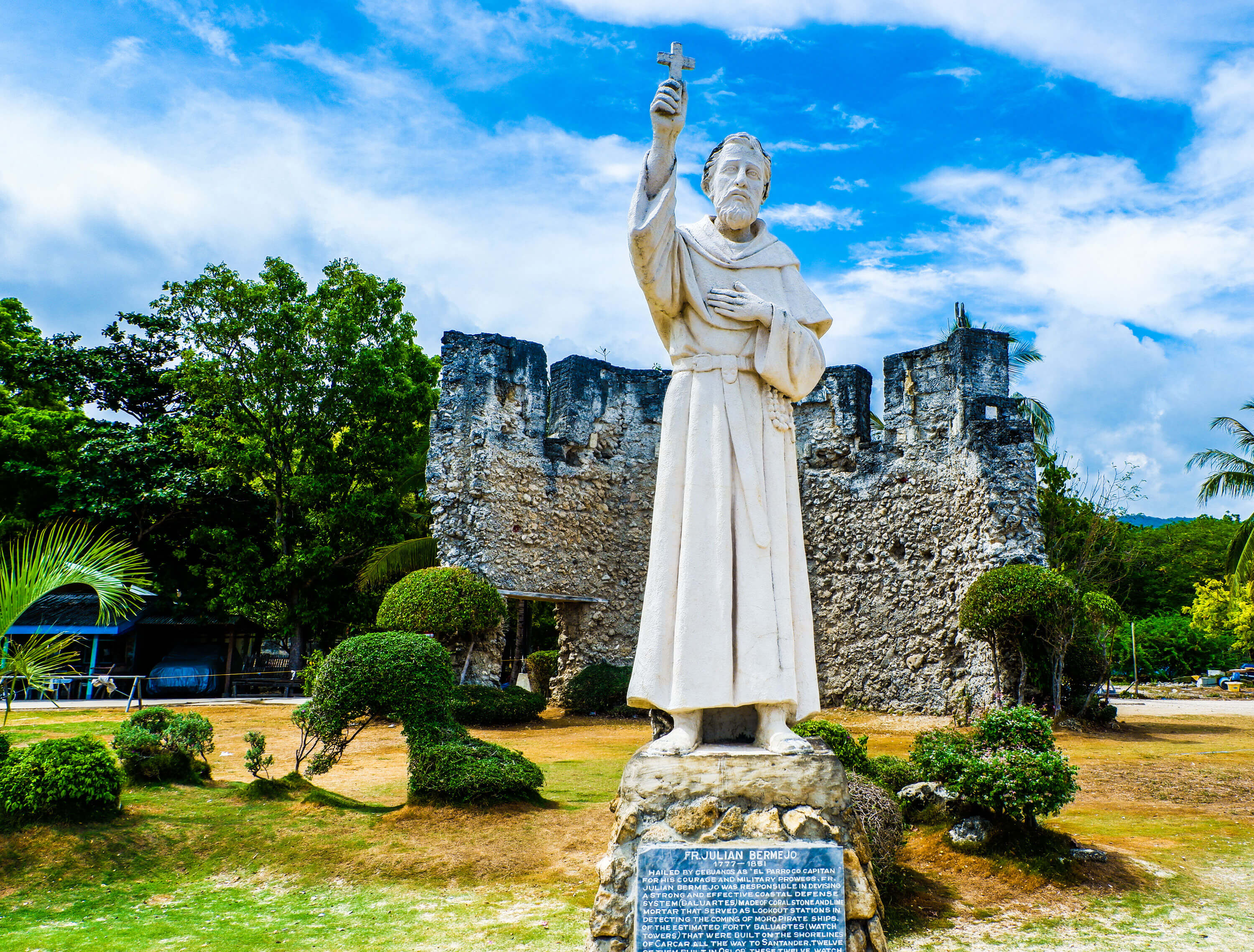 EL PADRE CAPITAN. The statue of Fr. Julian Bermejo OSA in Oslob stands in front of the ruins of the baluarte – the watchtower part of a network that he organized to protect southern Cebu towns from Moro raiders.