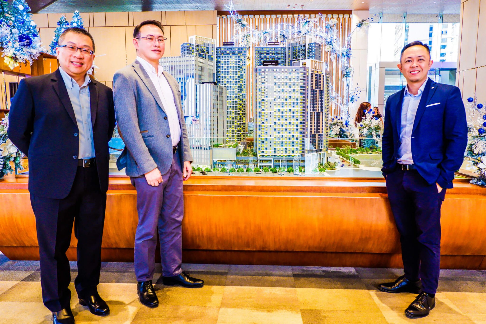 MANDANI BAY QUAY. Project Advisor Jeffrey Lun, Project Director Gilbert Ang, Sales Head Audrey Villa at a scale model of the Mandani Bay development during the announcement of their third and last residential tower in the second phase of the waterfront development.