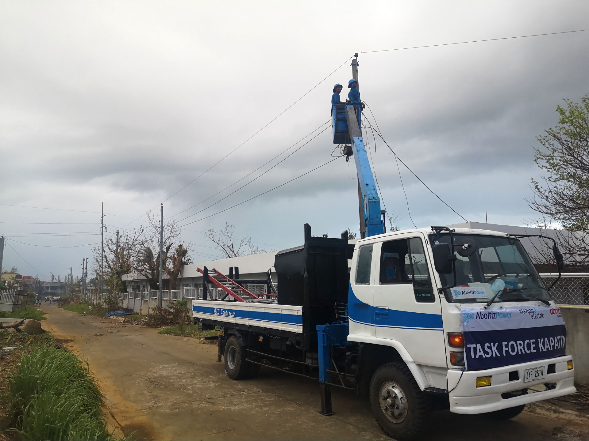 Linemen from the Visayan Electric Co. conduct line stringing works on one of the affected electric poles in Tiwi, Albay on Saturday, Nov. 14, 2020.