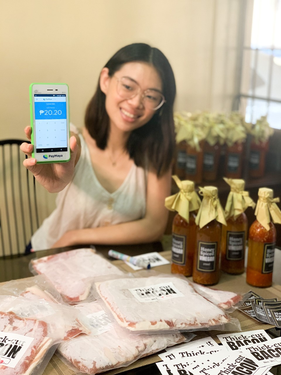 Entrepreneur Charmaine De Leon showcases her store’s PayMaya One Lite device which enables her to accept card and eWallet payments from customers - promoting safer and more convenient transactions in the new normal.