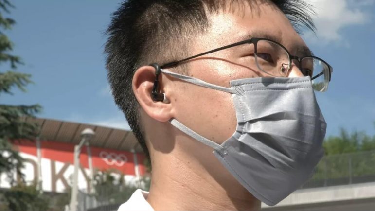 An intelligent ear-worn device helps keep track of the body temperature and heart rate of the Olympic onsite staff in Tokyo.