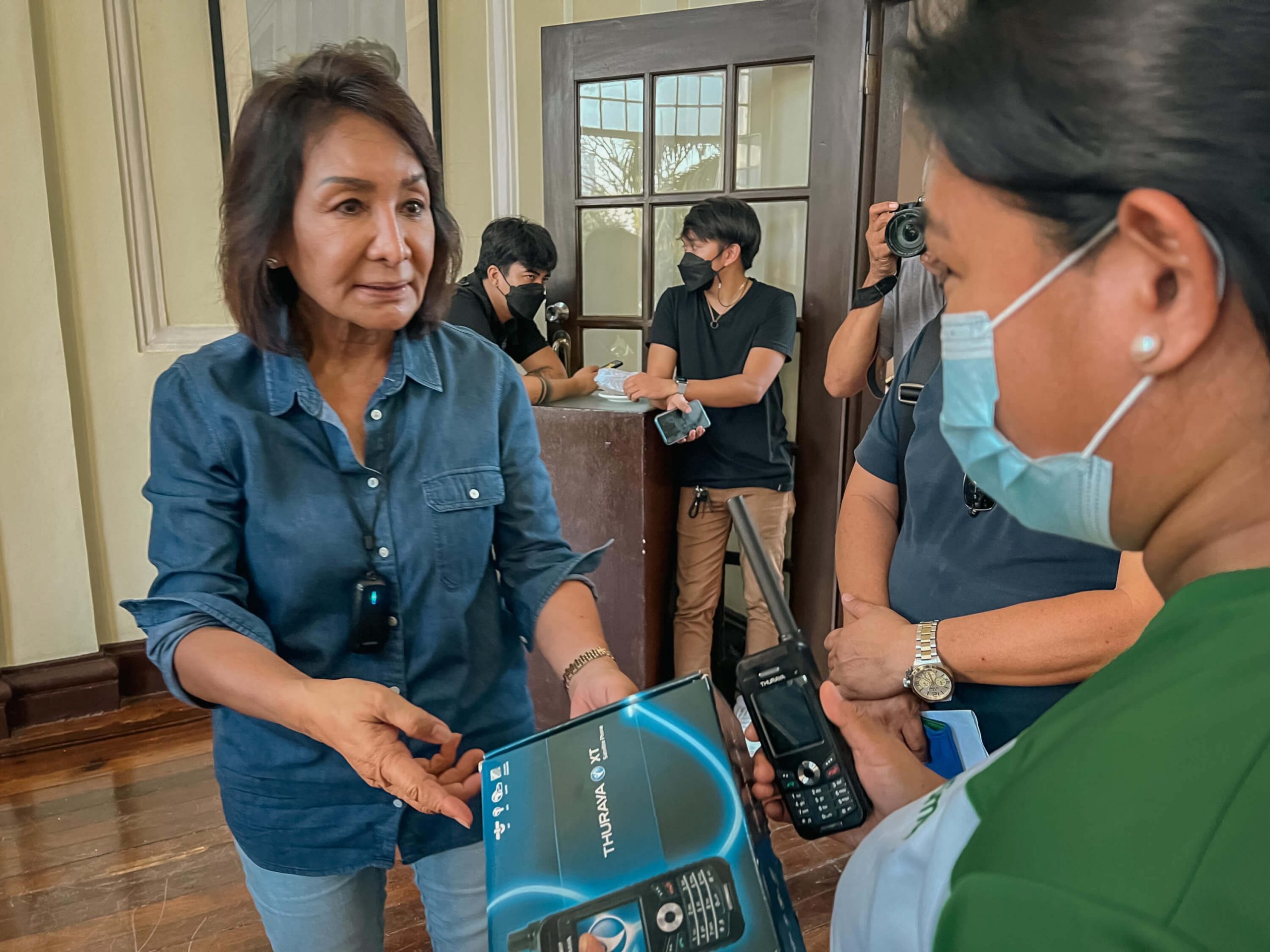 Cebu Governor Gwendolyn Garcia receives from Smart Group Corporate Communications VisMin Manager Marylou Gocotano a satellite phone donated by the telco to help in communications as part of disaster recovery in the wake of Typhoon Odette.