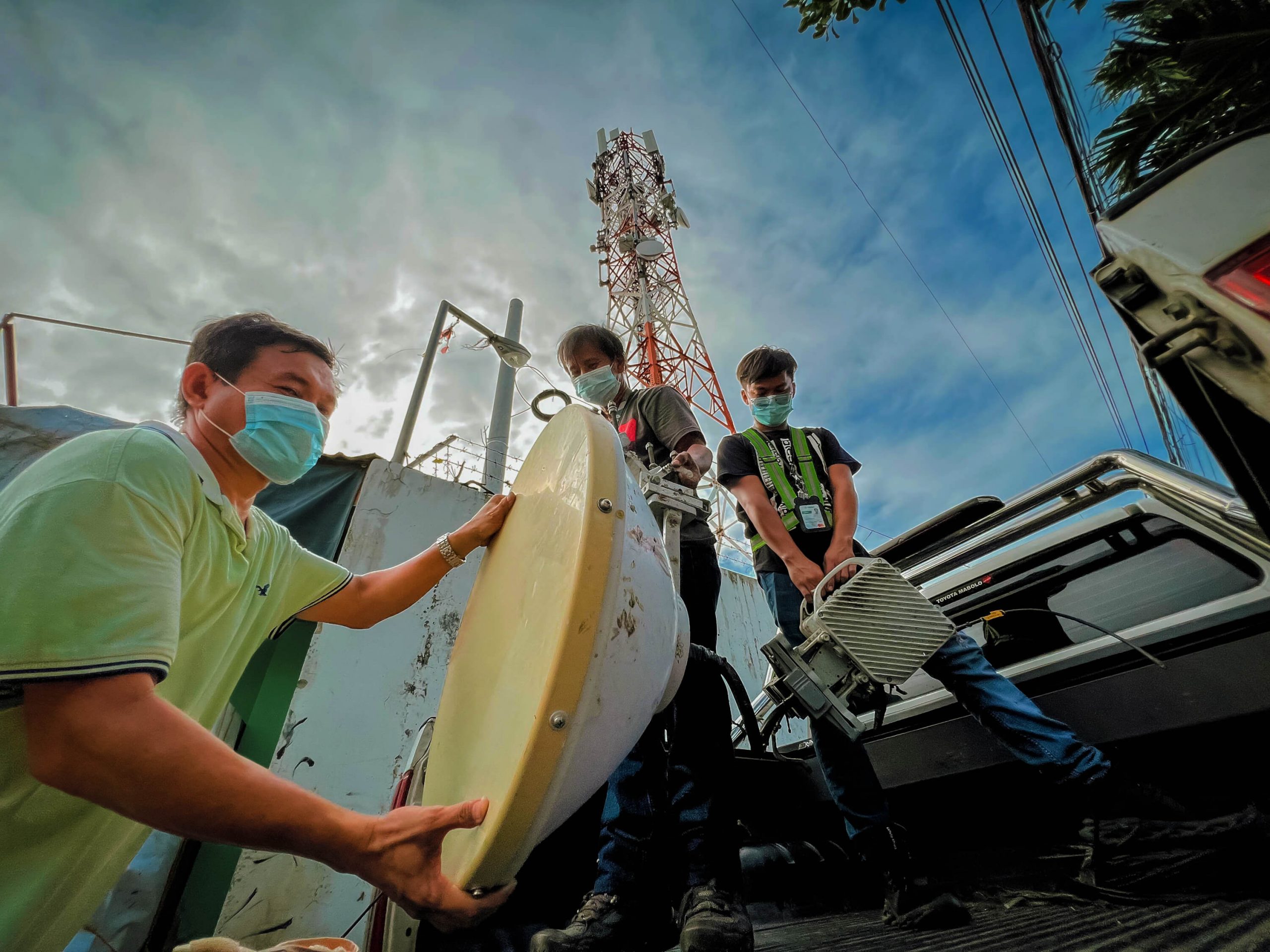 Smart engineers carry outdoor equipment weighing 60 kilograms for a cell site serving Cordova, Cebu.